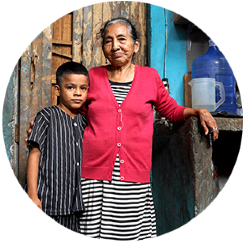 a old woman hugging a boy in their house