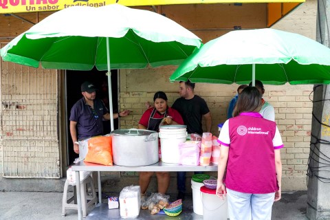 a group of people standing in front of a restaurant